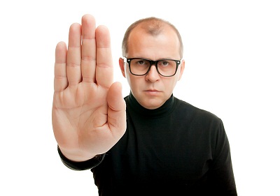 Man in black showing rejective hand gesture, isolated on white